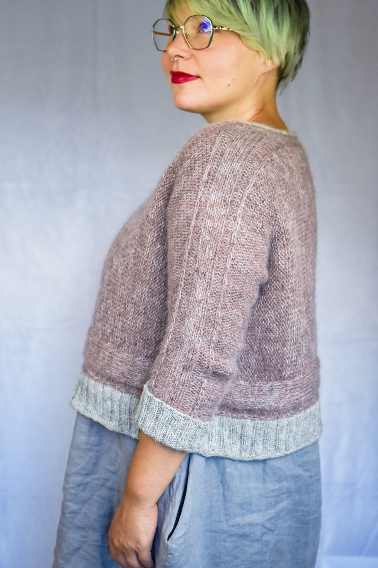 Hazy Lanes cropped sweater knit sideways in dusty pink wool and mohair with silver gray ribbed cuffs and hem.