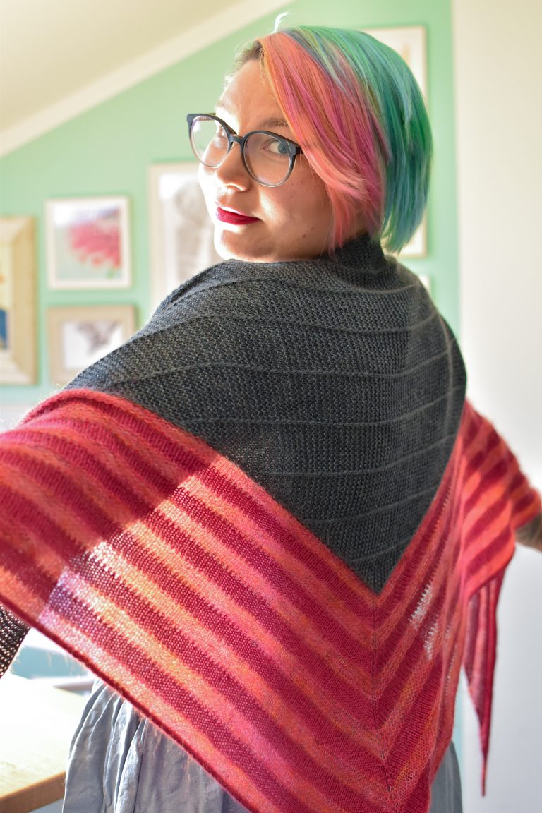 Stay At Home triangle shawl in dark green center panel and pink wool and mohair lace stripes.