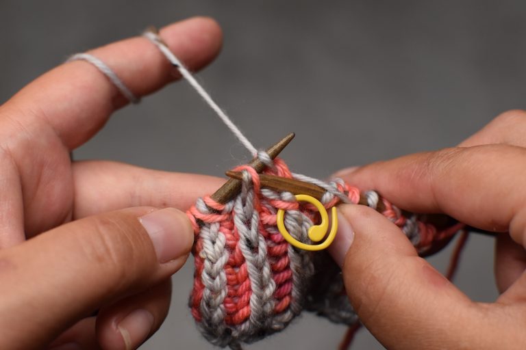 Step 7: Pass the next stitch (and its yarn-over) over and off the needle.