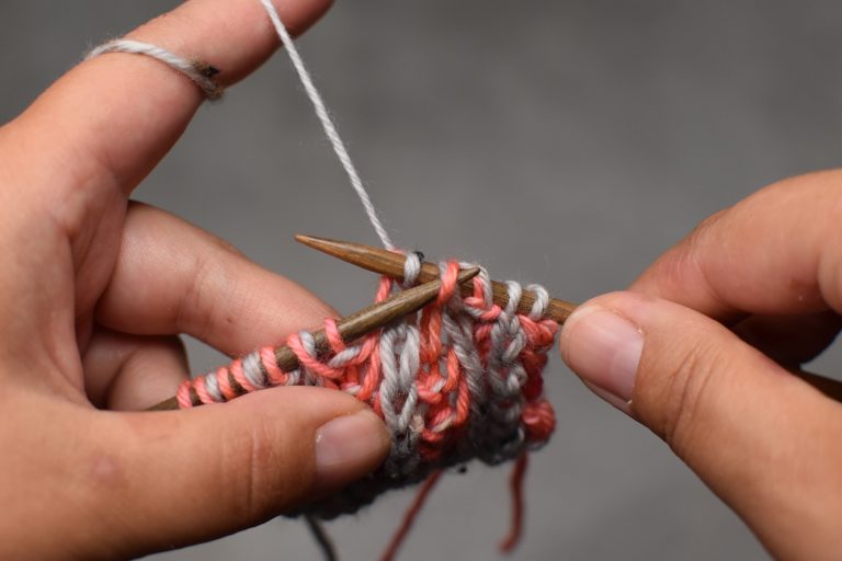 Step 3: Pass the slipped stitch (and its yarn-over) over and off the needle to complete the decrease.