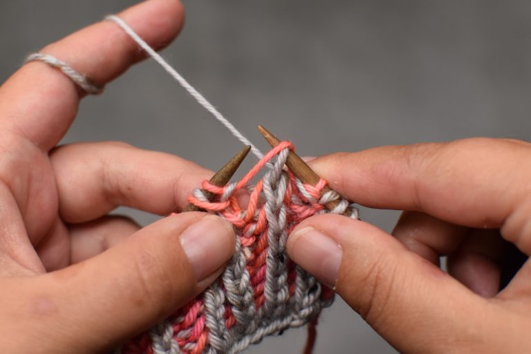 Step 1: Slip stitch (and its yarn-over) knit-wise onto the right-hand needle.