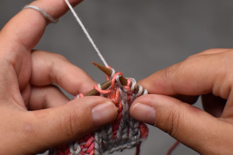 Step 3: Pass the slipped stitch over the knit stitch and off the needle.