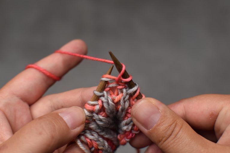 Step 2: Yarn-over by bringing the yarn over the needle to the back.