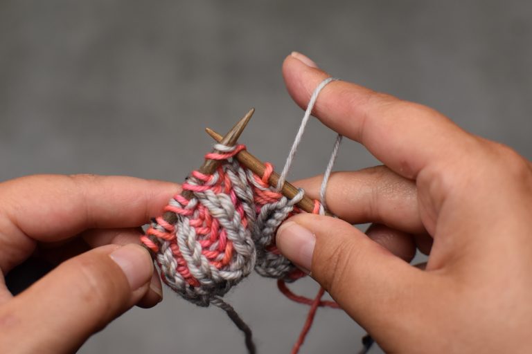 Step 1: With Yarn in front, insert the needle from front to back through the stitch and its yarn-over.