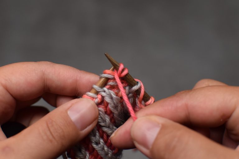 Step 2: Yarn over (bring the yarn over the needle to the back and under the needle to the front again).